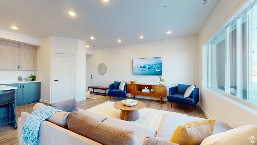 Living room featuring light wood-type flooring and recessed lighting
