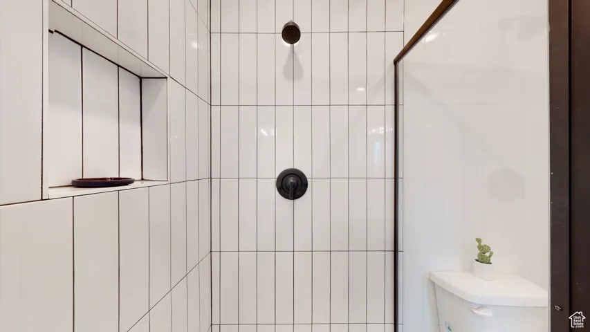 Bathroom with a tile shower and toilet