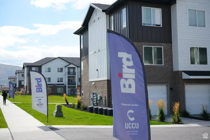 View of building exterior featuring a garage and a residential view