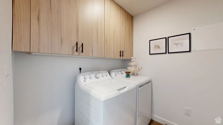 Laundry area with cabinet space and separate washer and dryer