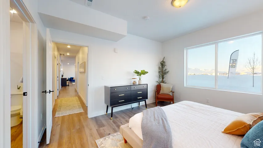 Bedroom with light wood-type flooring and baseboards