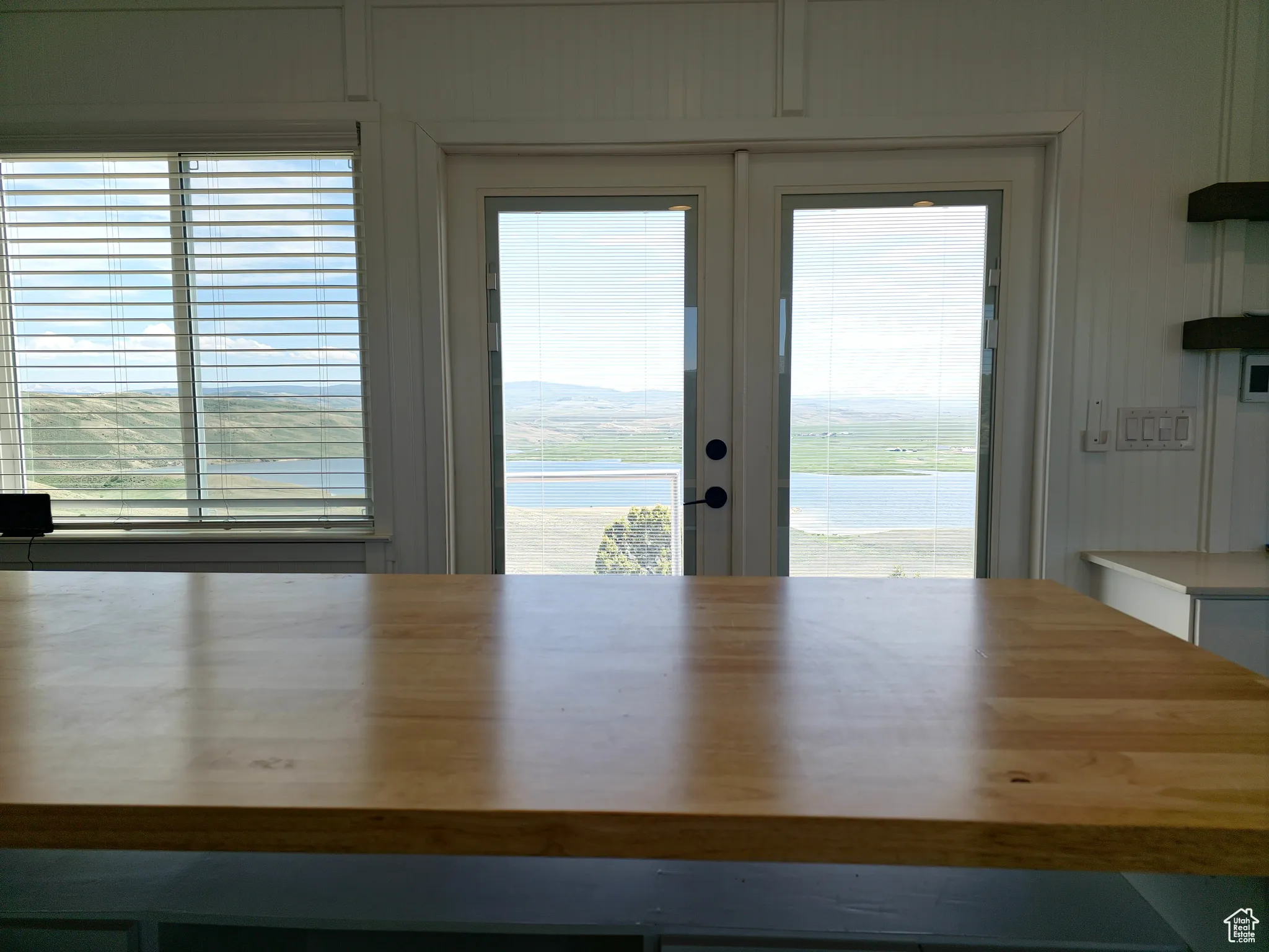 Unfurnished dining area featuring a water view and french doors