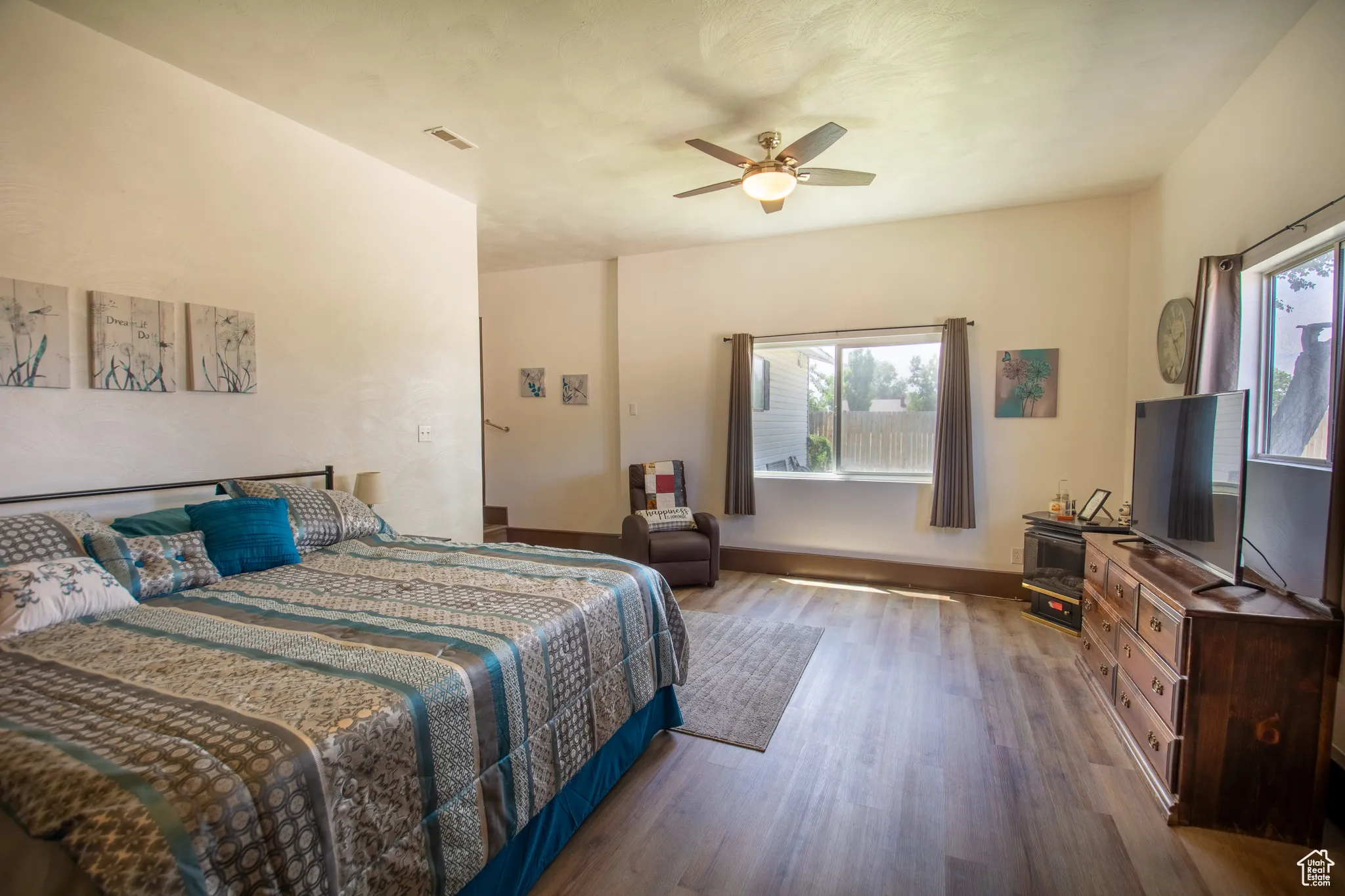 Bedroom featuring wood finished floors and ceiling fan