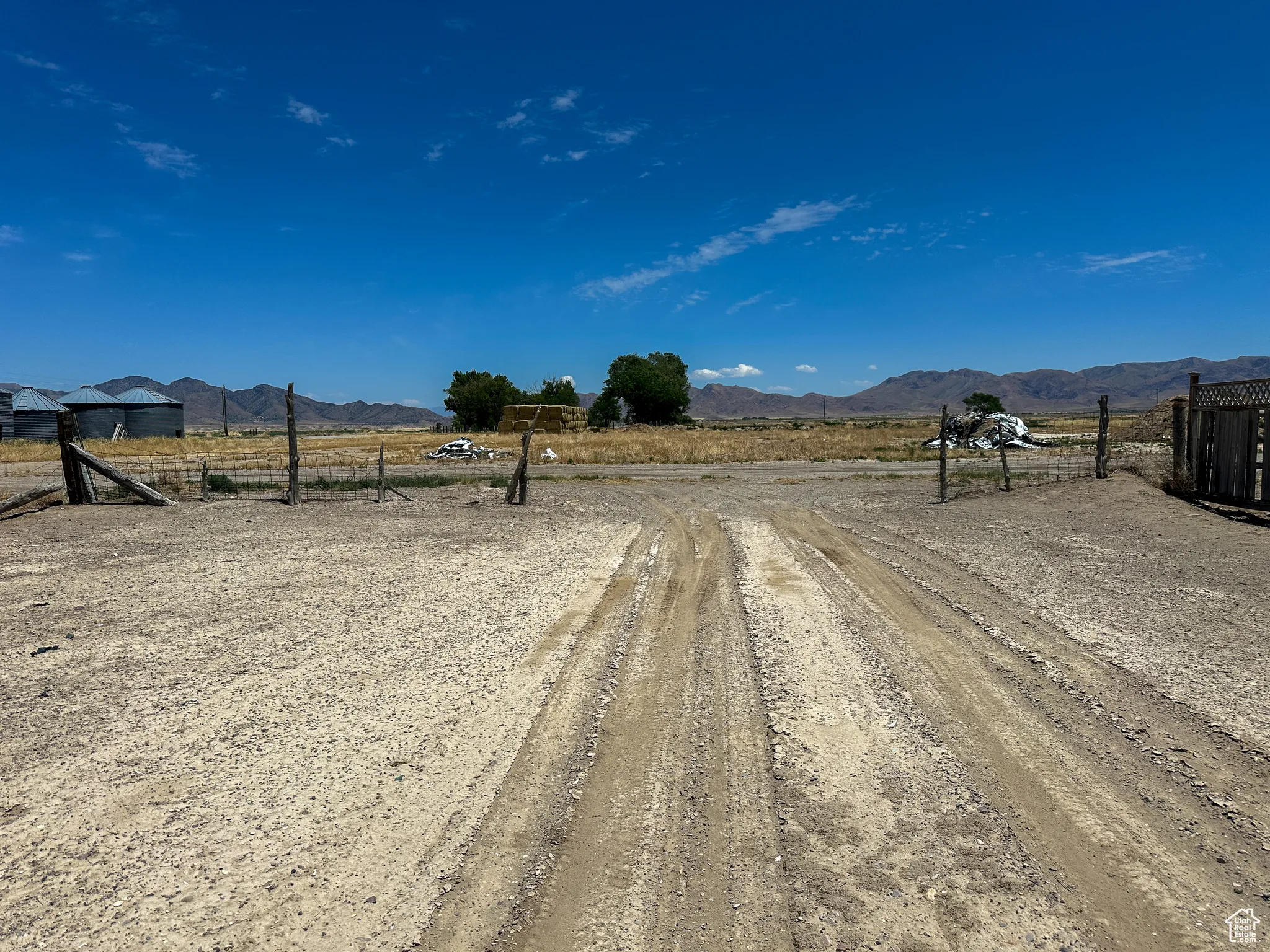 View of dirt / gravel road featuring a view of countryside and a mountain view