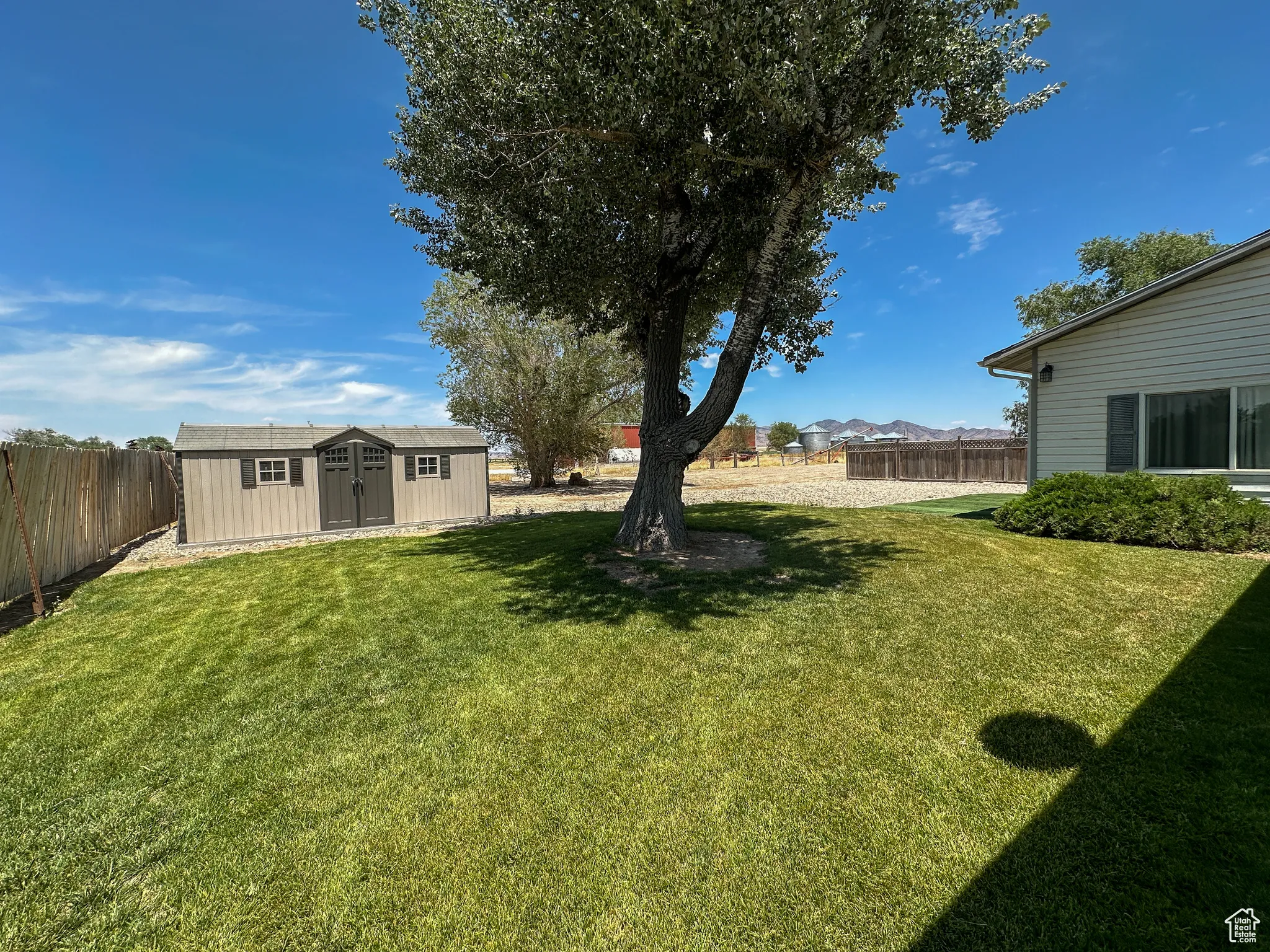 View of yard with a storage unit