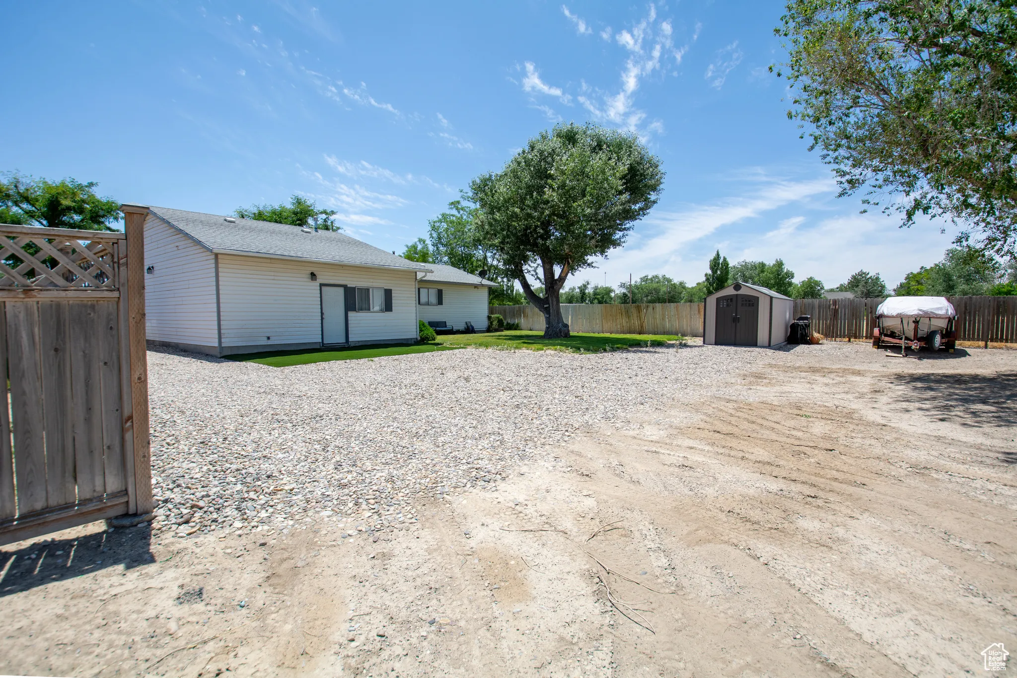 Fenced backyard with a storage shed