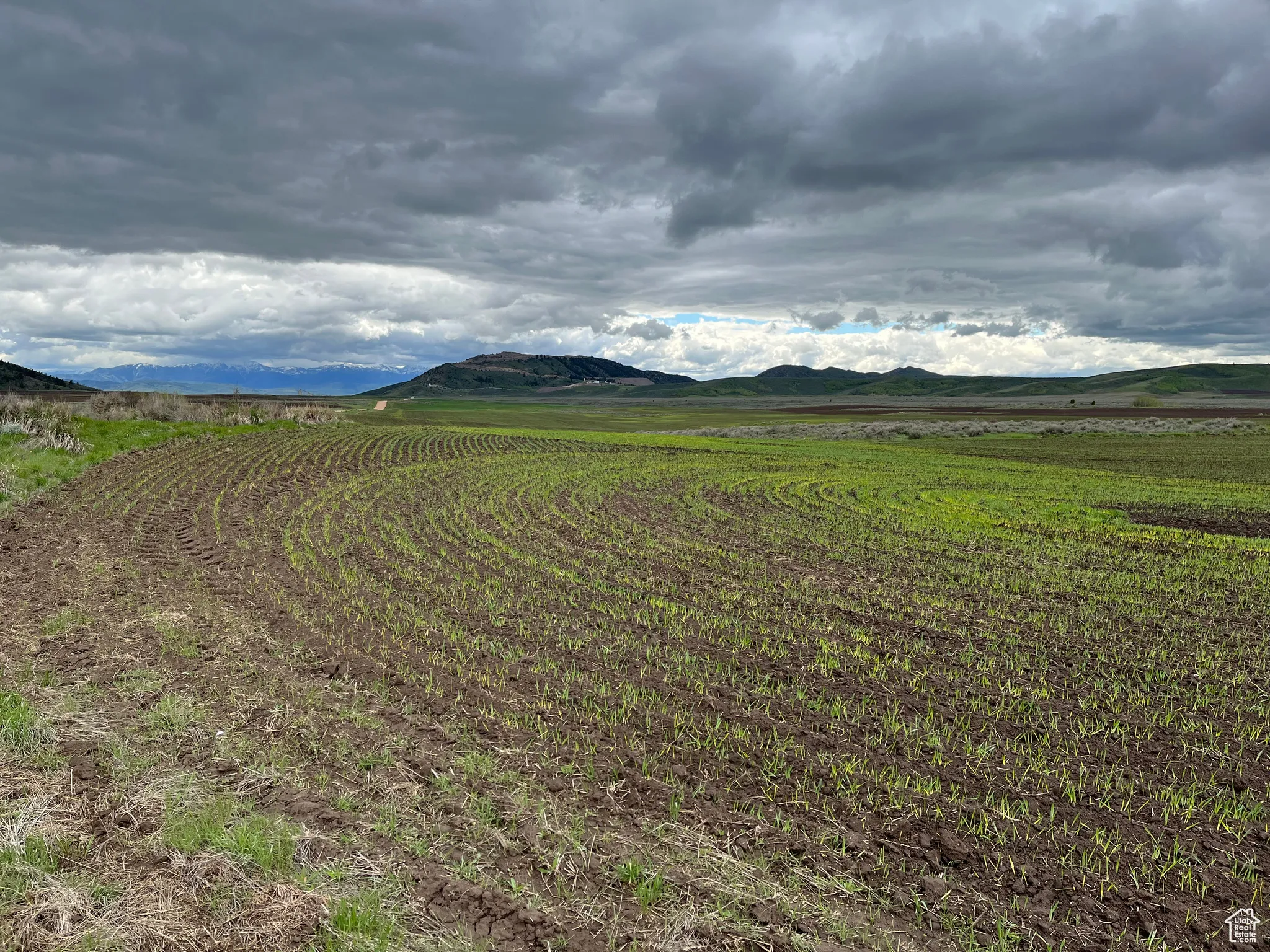 View of mountain backdrop with rural landscape