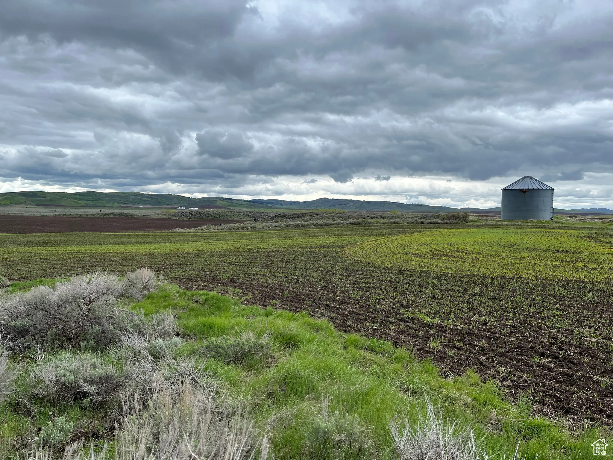 View of mountain backdrop with rural landscape