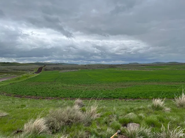 View of mountain backdrop with rural landscape
