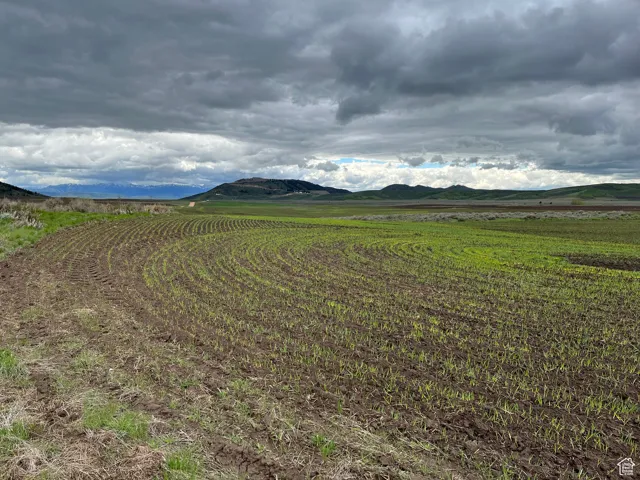 View of mountain backdrop with rural landscape