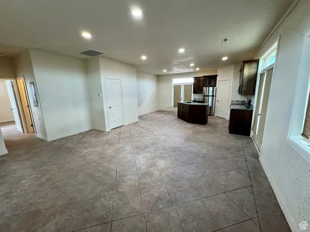 Unfurnished living room featuring recessed lighting and a textured ceiling