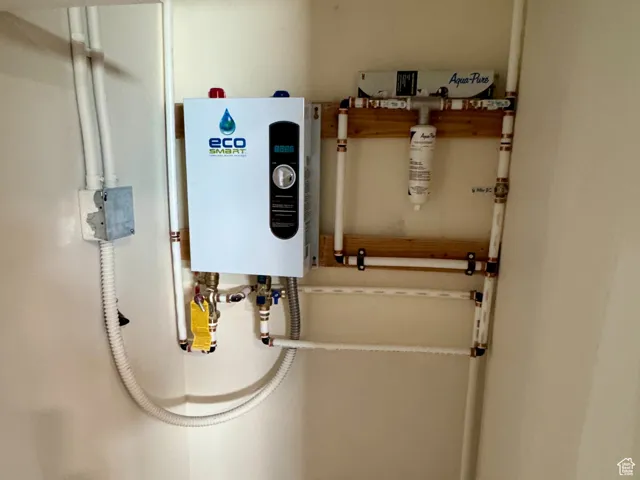 Utility closet featuring tankless water heater