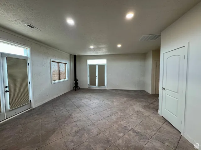 Unfurnished room featuring recessed lighting and a textured ceiling