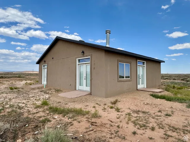Rear view of house with french doors and stucco siding