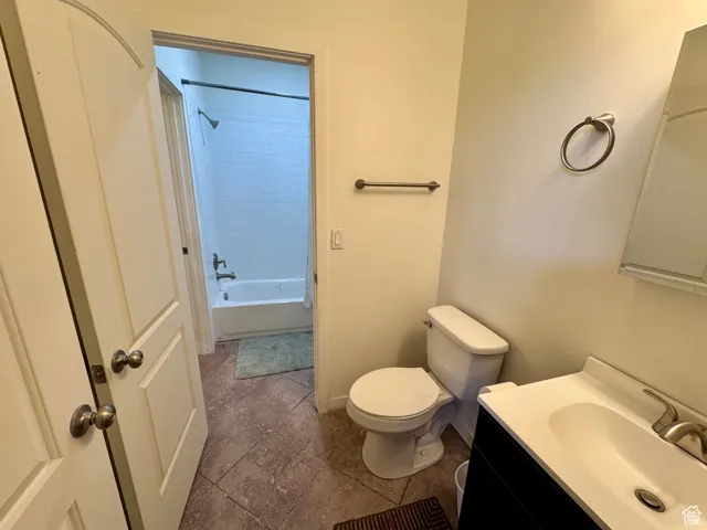 Bathroom featuring vanity,  shower combination, and tile patterned flooring