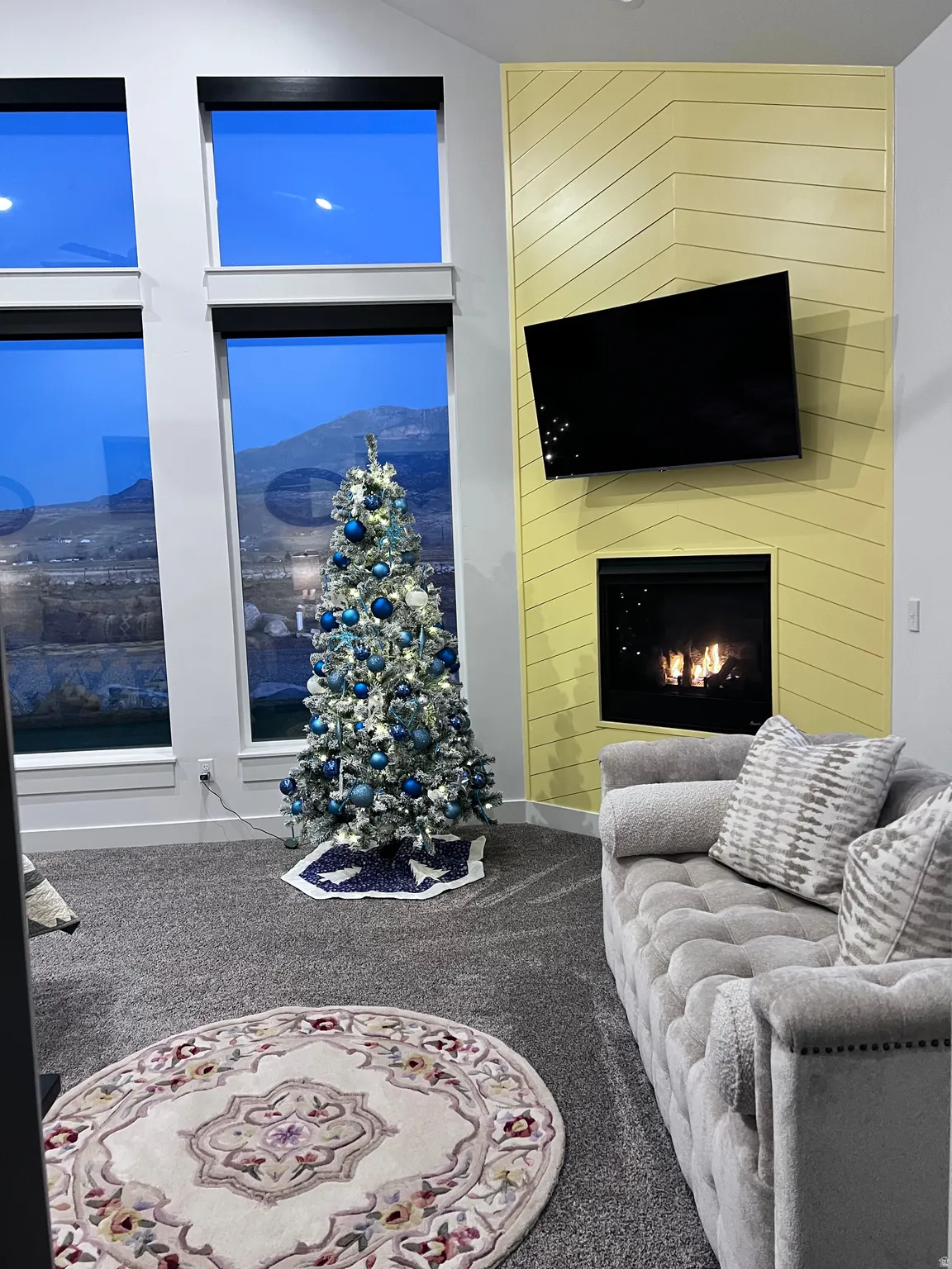Living area with carpet floors and a large fireplace