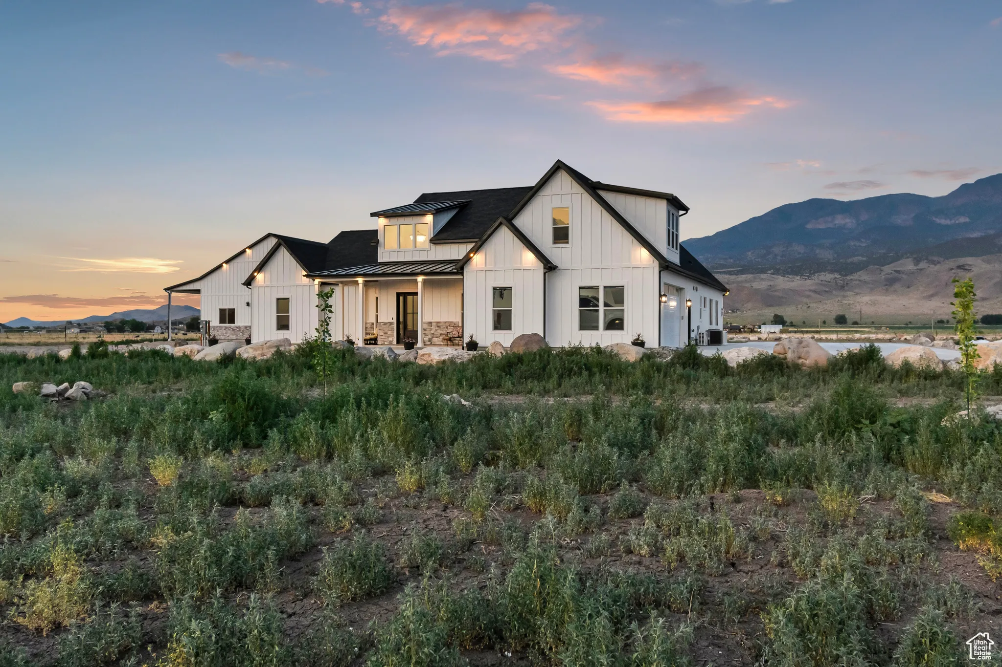 Modern farmhouse with a standing seam roof, board and batten siding, a metal roof, and a mountain view