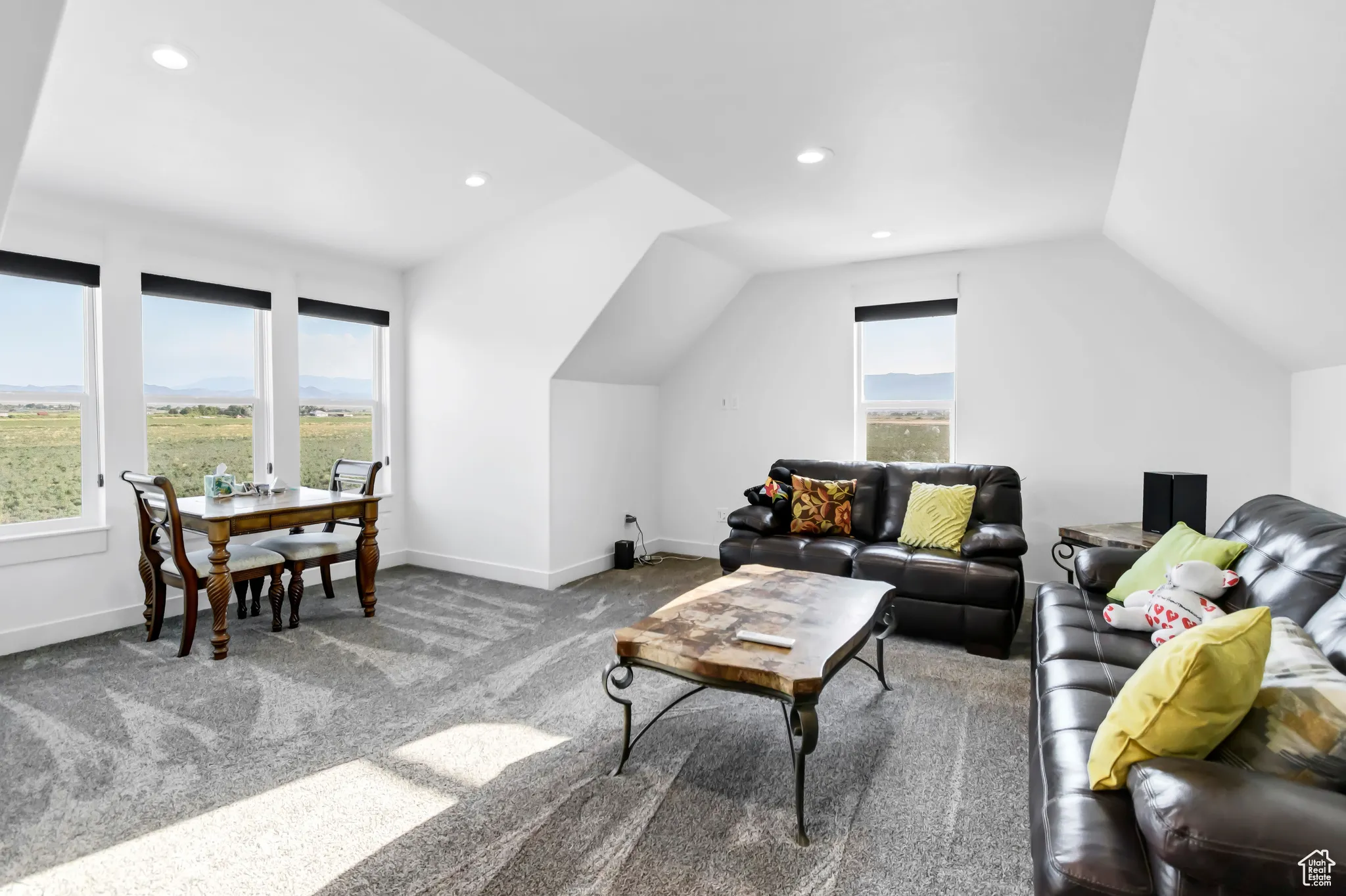 Living room featuring vaulted ceiling, healthy amount of natural light, carpet, and recessed lighting