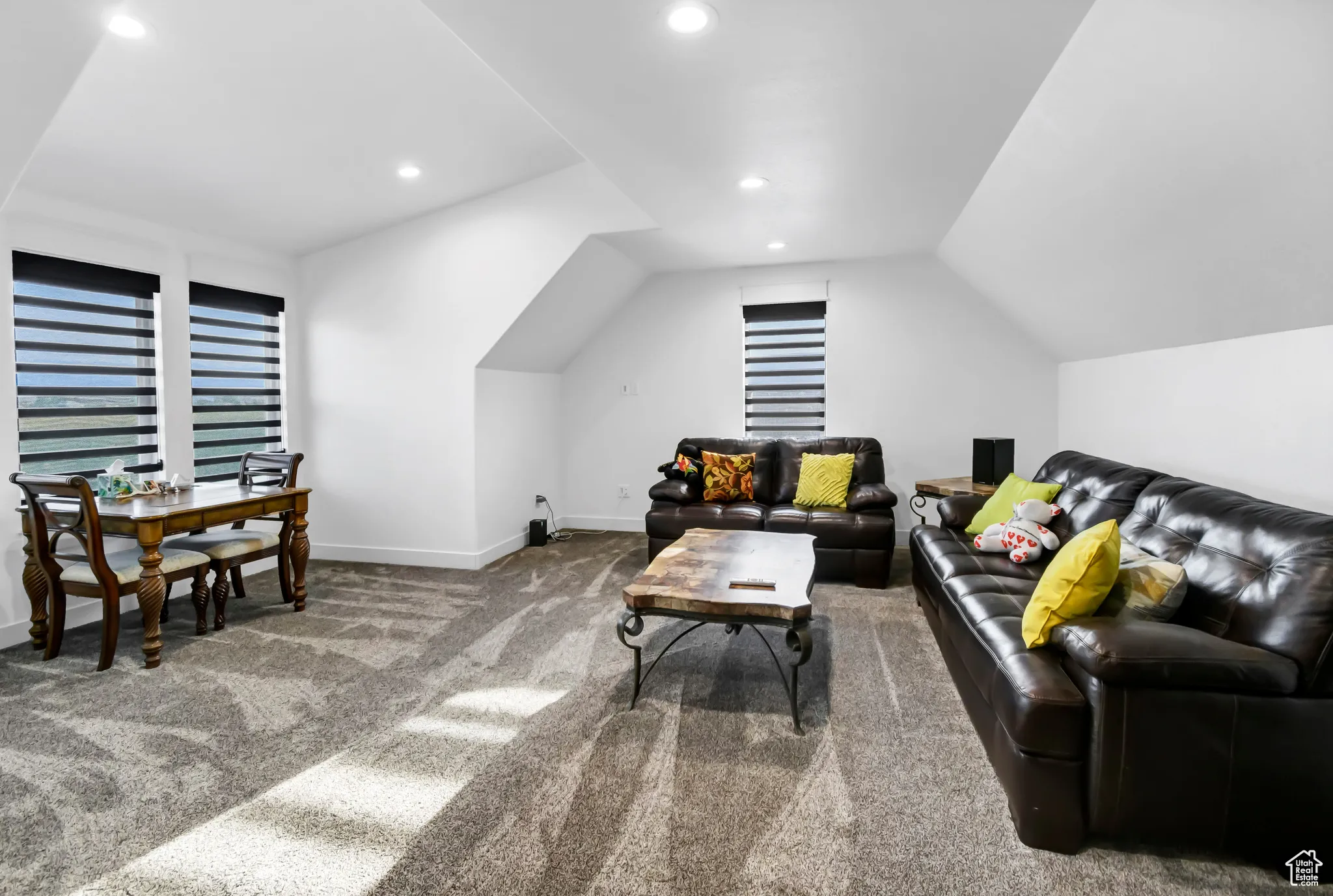 Living room with carpet, lofted ceiling, and recessed lighting