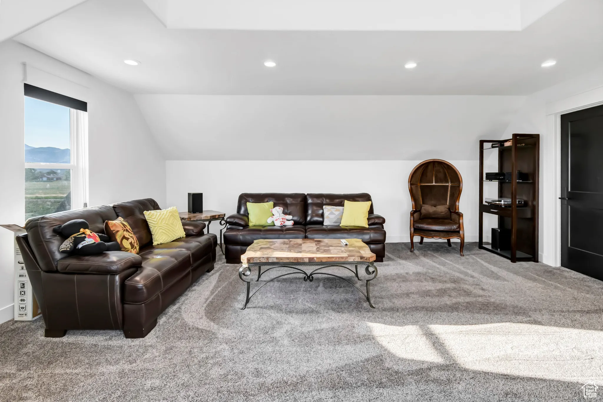 Living room featuring carpet floors, recessed lighting, and vaulted ceiling
