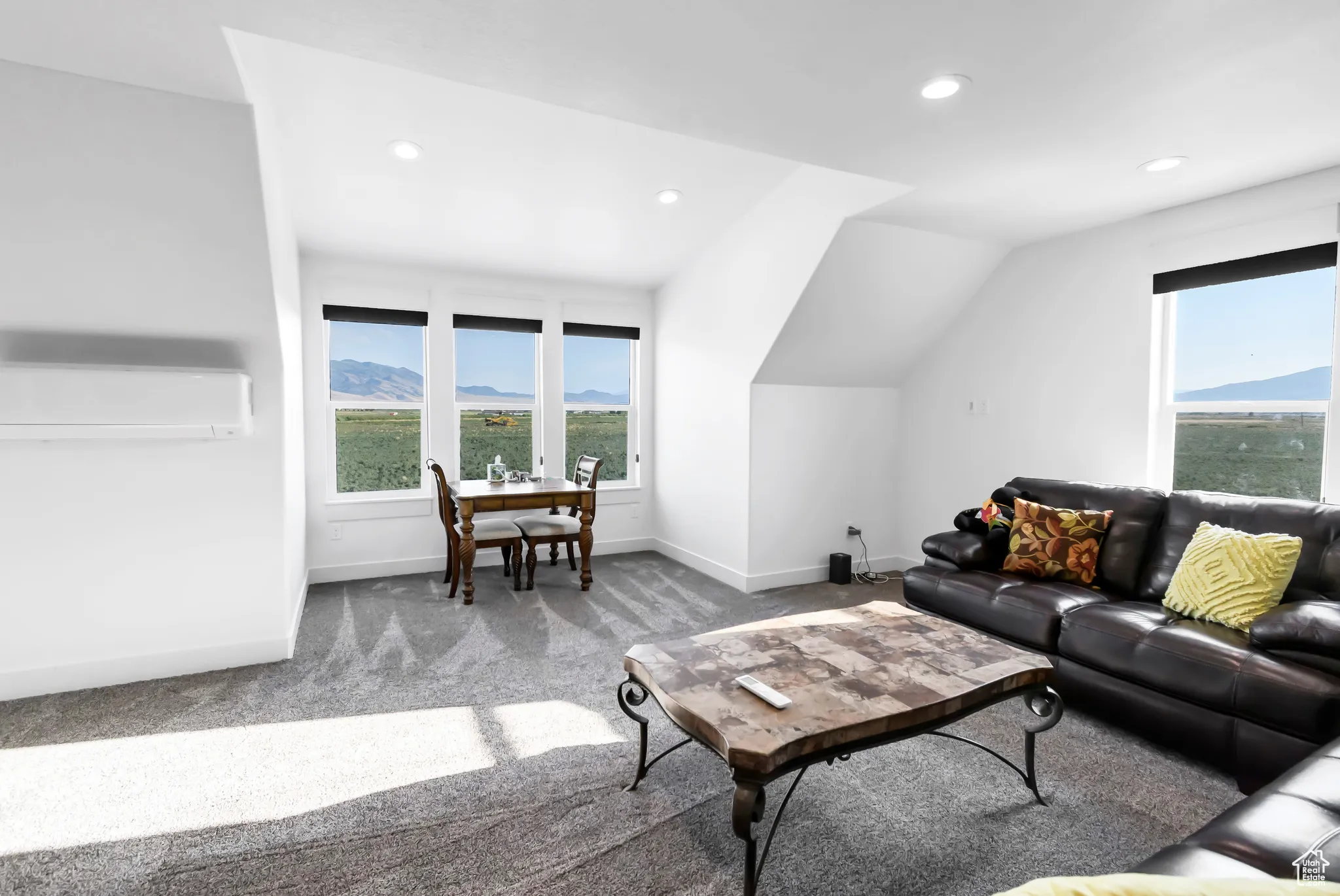 Living room with a wall unit AC, carpet floors, recessed lighting, and lofted ceiling