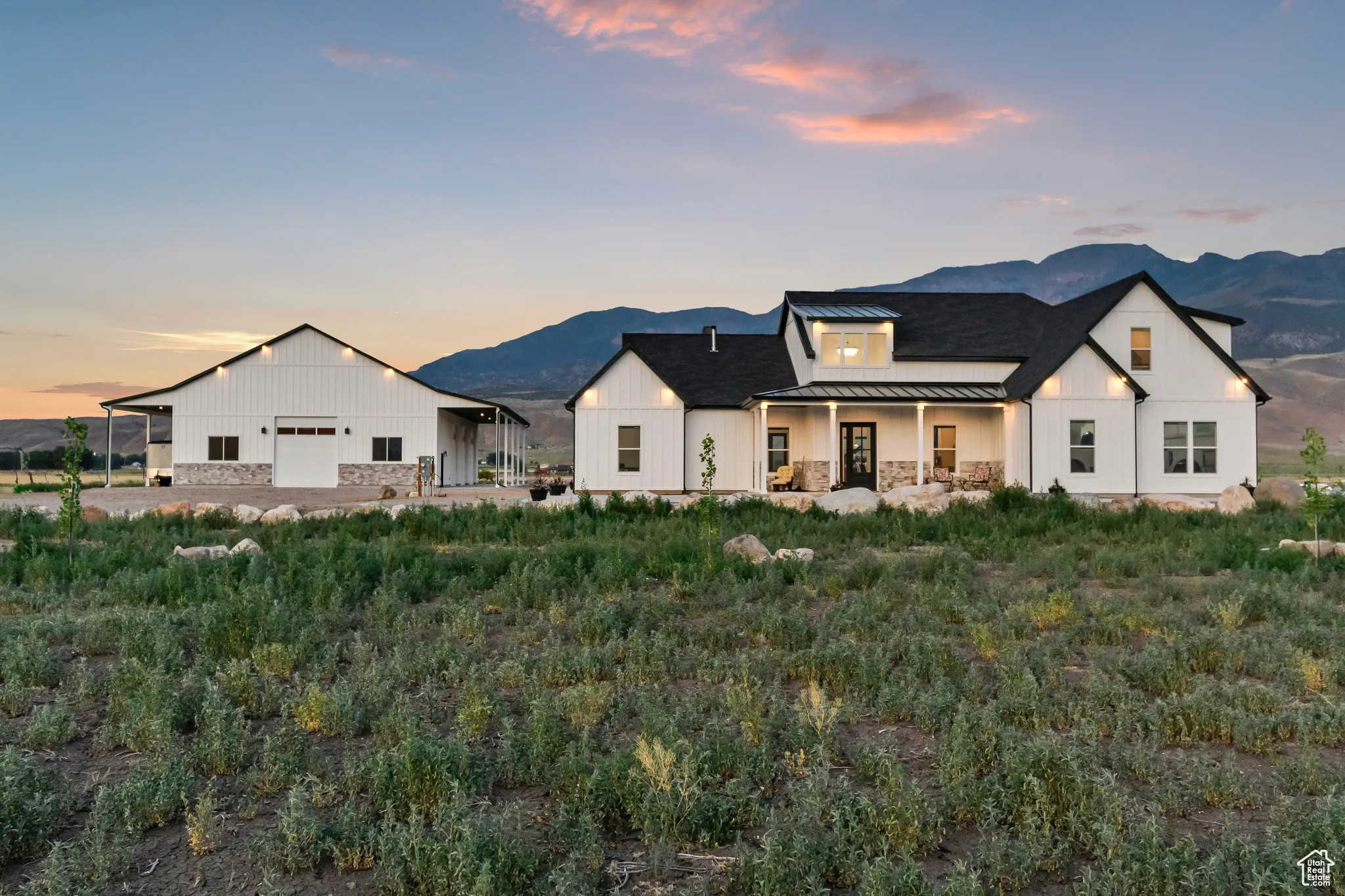 View of front of home with a standing seam roof, a mountain view, and board and batten siding