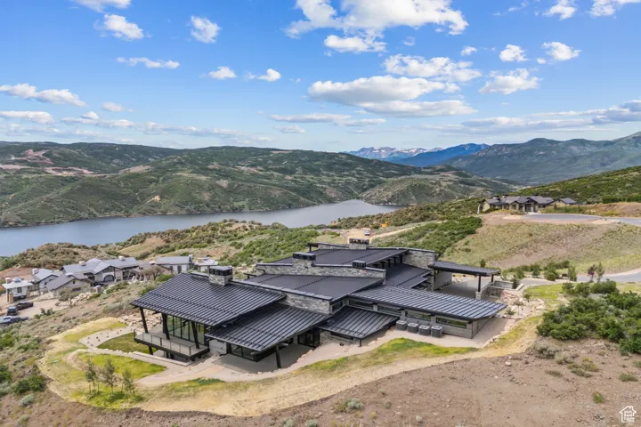 Aerial view of property and surrounding area with a water and mountain view