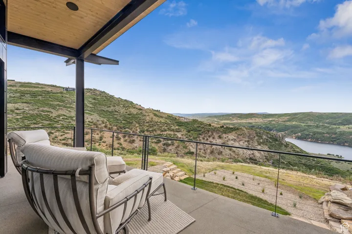 Patio / terrace with a water and mountain view