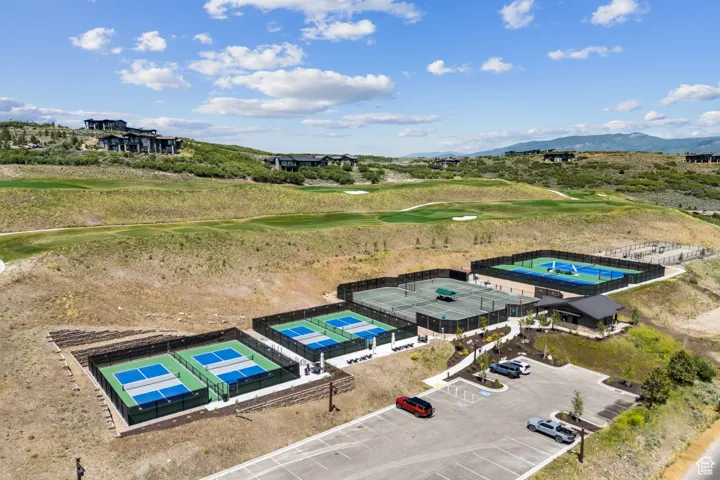 Drone / aerial view of a golf club and a mountain backdrop