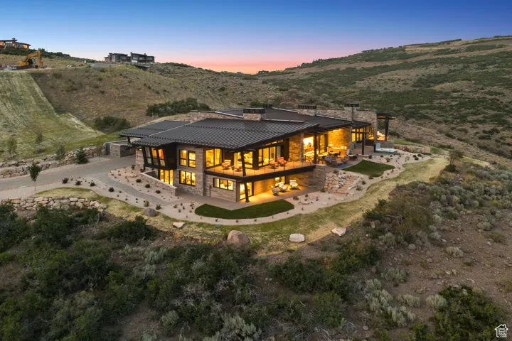 Back of property featuring a patio area, a standing seam roof, a metal roof, and a mountain view