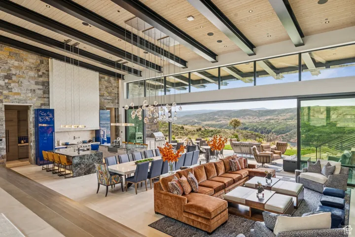 Living area featuring wood finished floors, a mountain view, a wood ceiling with exposed beams, and a high ceiling
