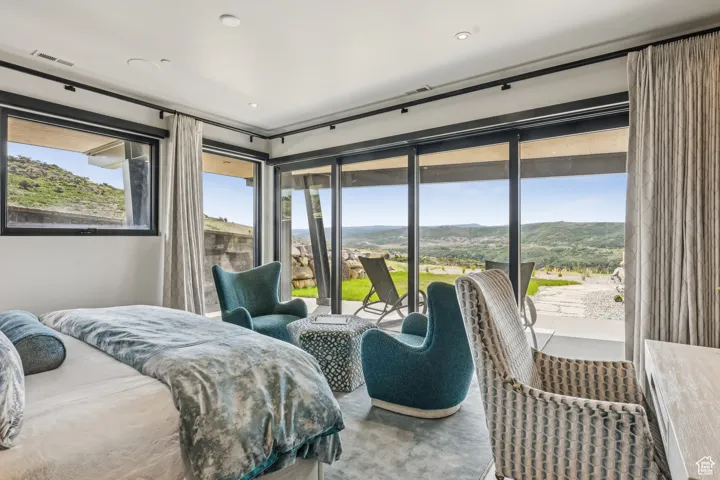 Bedroom featuring access to exterior and a mountain view