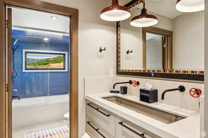 Full bath featuring tasteful backsplash, a bathtub, and vanity