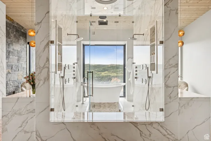 Bathroom featuring a marble finish shower, a soaking tub, and wooden ceiling