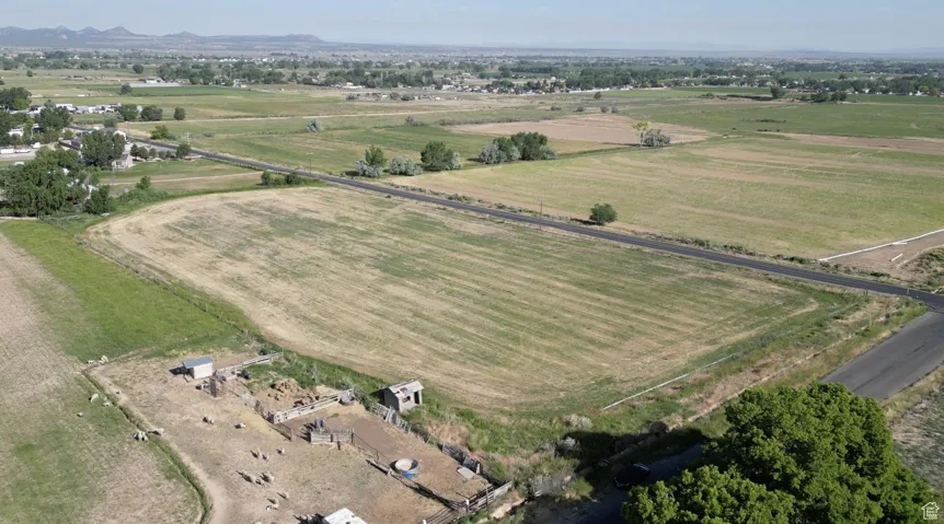 Aerial view of property and surrounding area featuring rural landscape and mountains