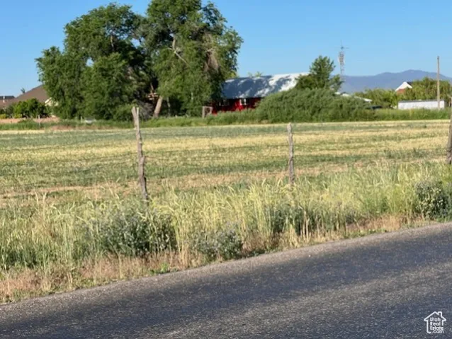 View of yard featuring a view of rural / pastoral area and a mountain view