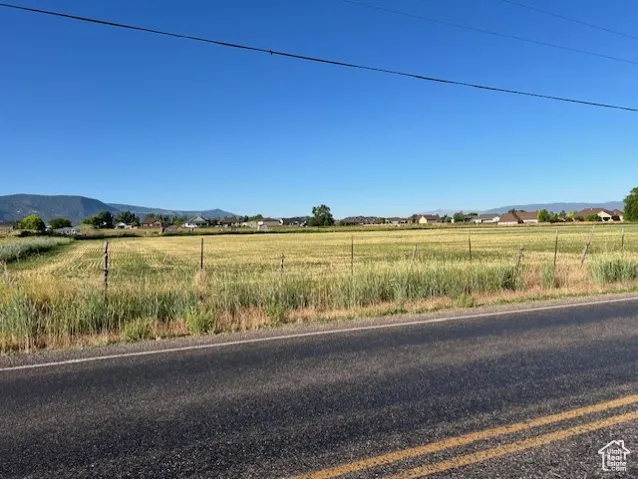 View of asphalt road with a mountain view and a view of rural / pastoral area