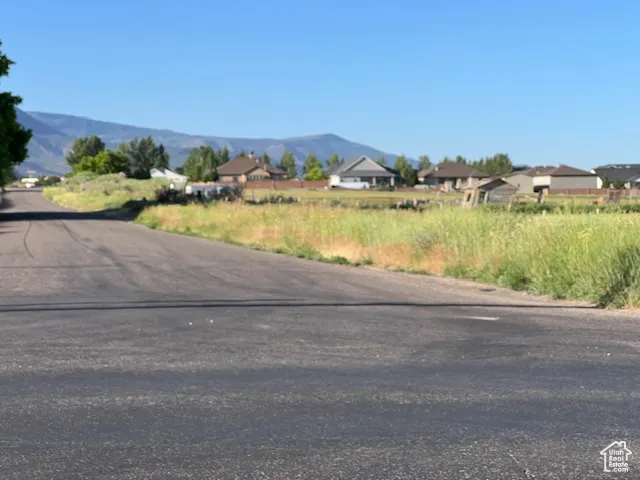 View of asphalt street featuring a mountain view and a residential view