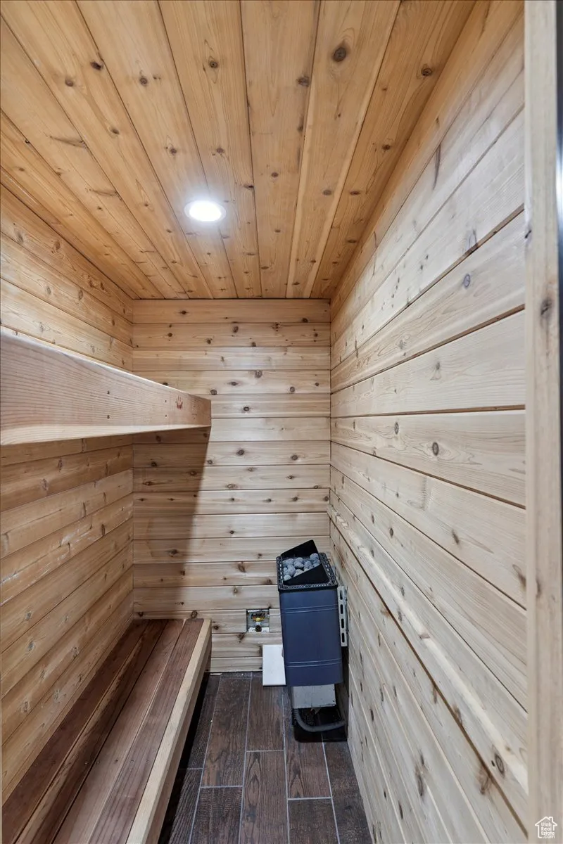 Sauna with wooden ceiling, wood walls, and wood finished floors