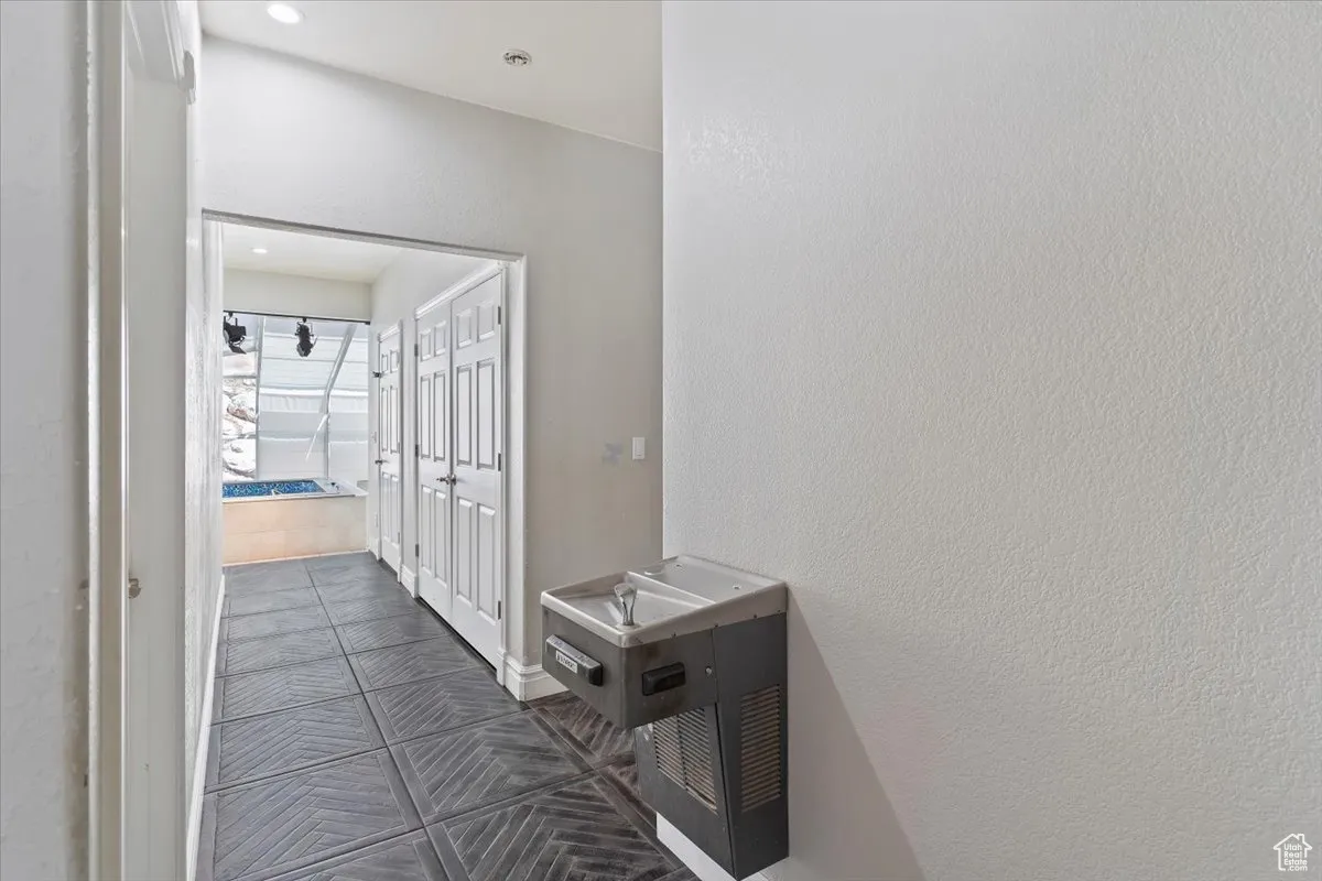 Hall with dark tile patterned floors