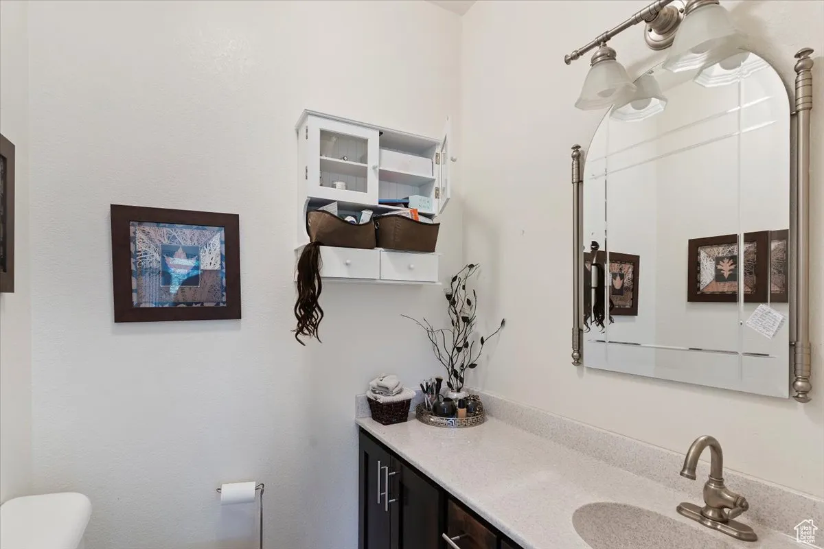 Half bath featuring toilet and vanity