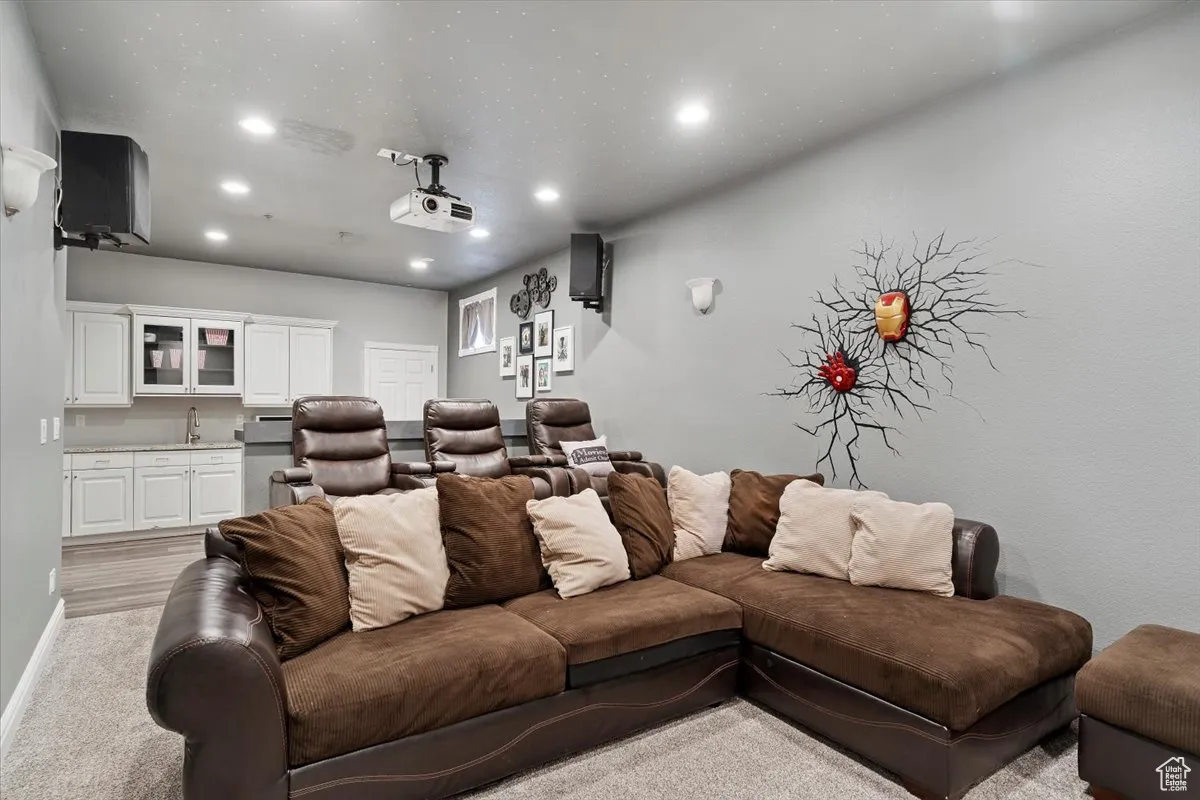 Cinema room with recessed lighting and light carpet
