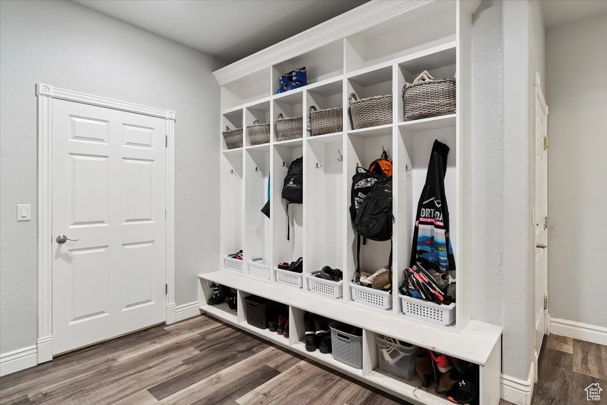 Mudroom featuring wood finished floors and baseboards
