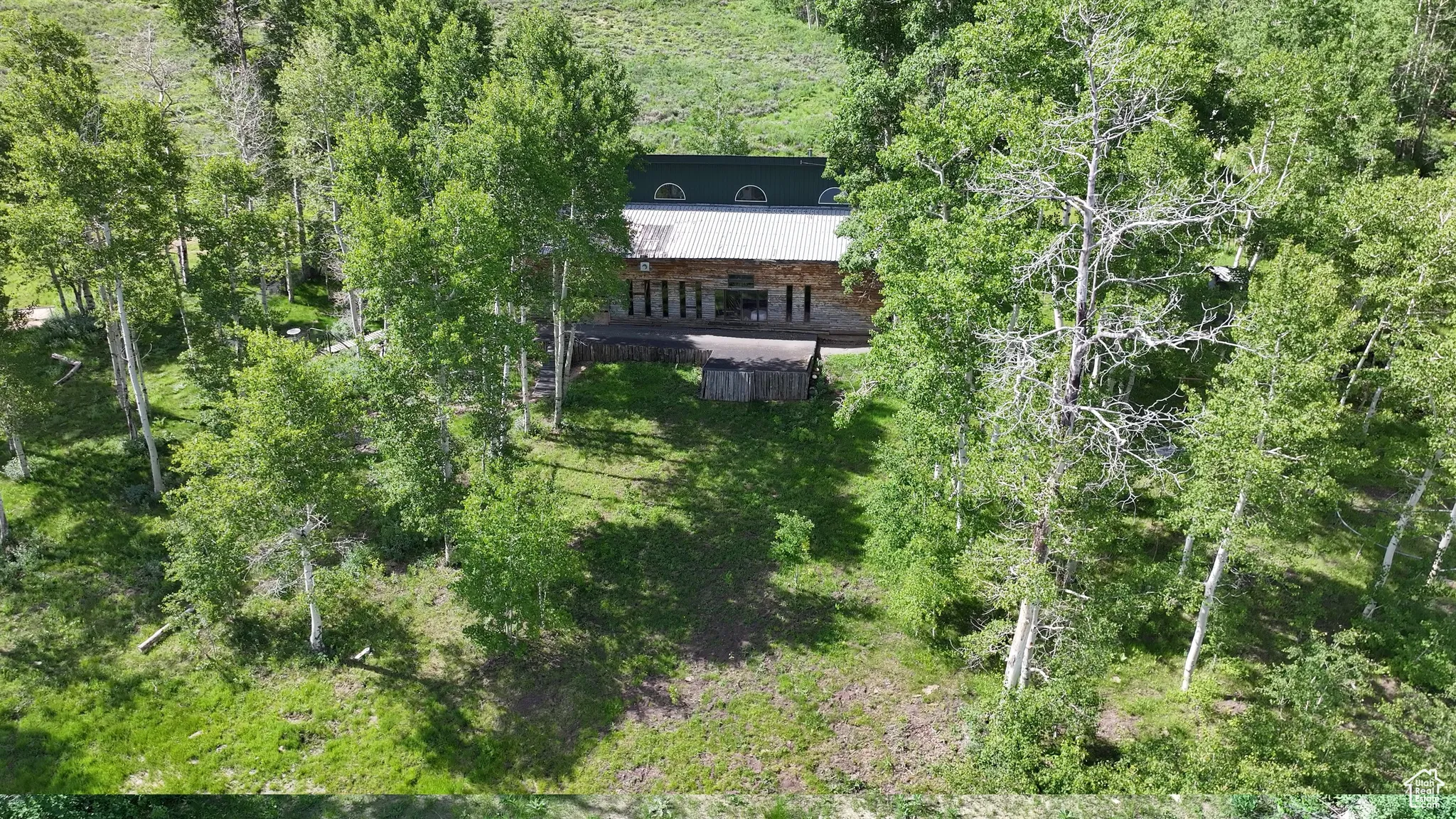 View from above of property with a heavily wooded area