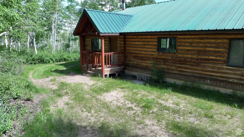 View of home's exterior featuring log siding and a metal roof