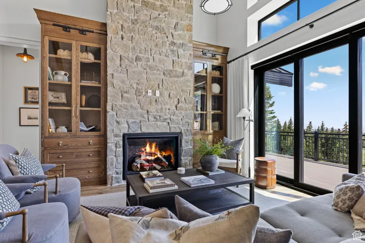 Living room with plenty of natural light, a fireplace, and wood finished floors
