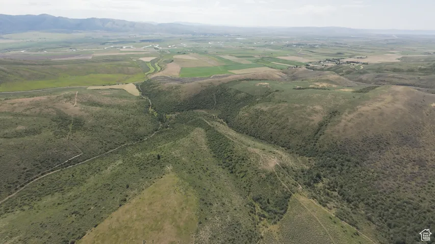 Aerial view of property's location with mountains and rural landscape