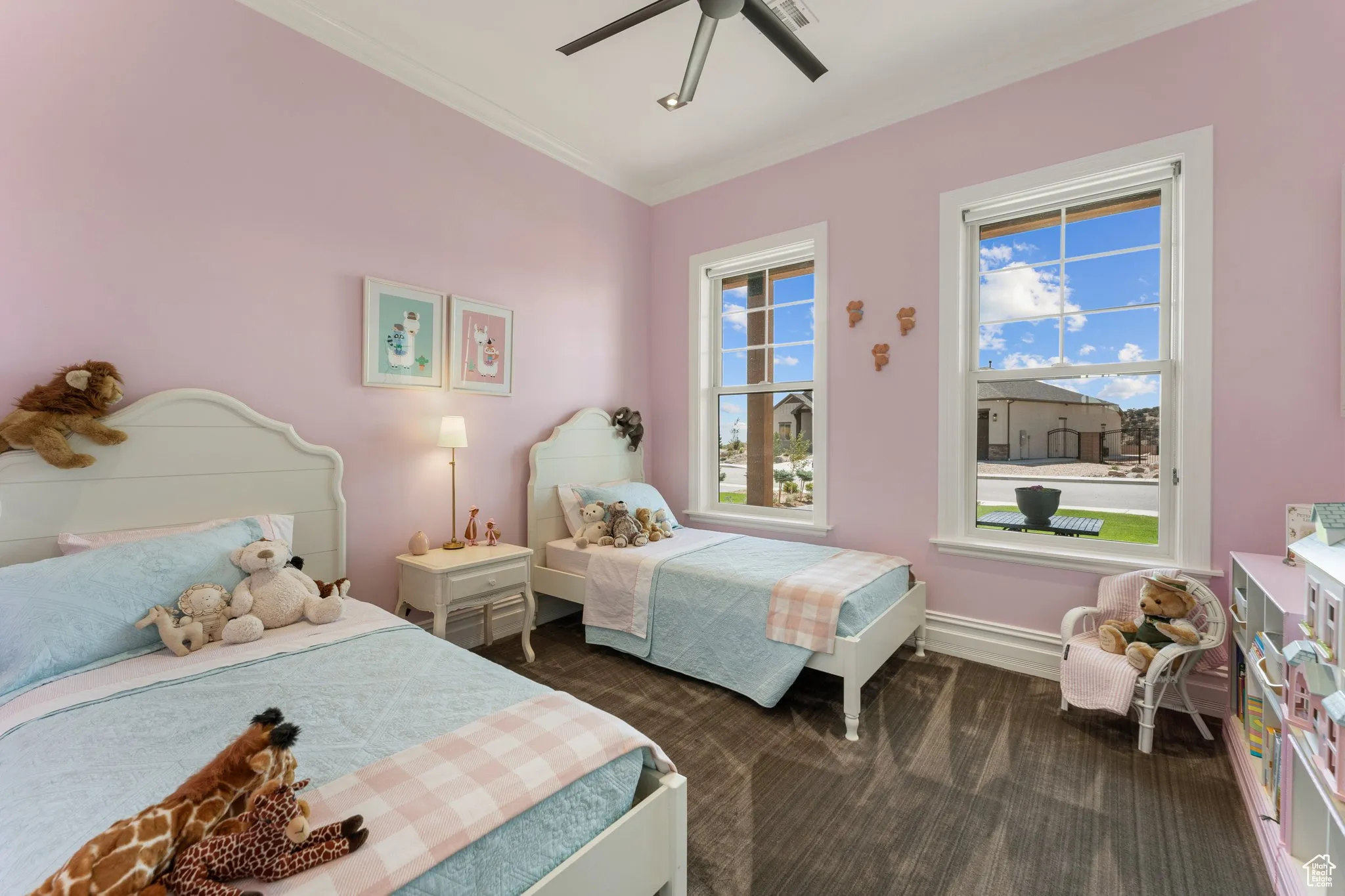 Carpeted bedroom featuring ornamental molding and ceiling fan
