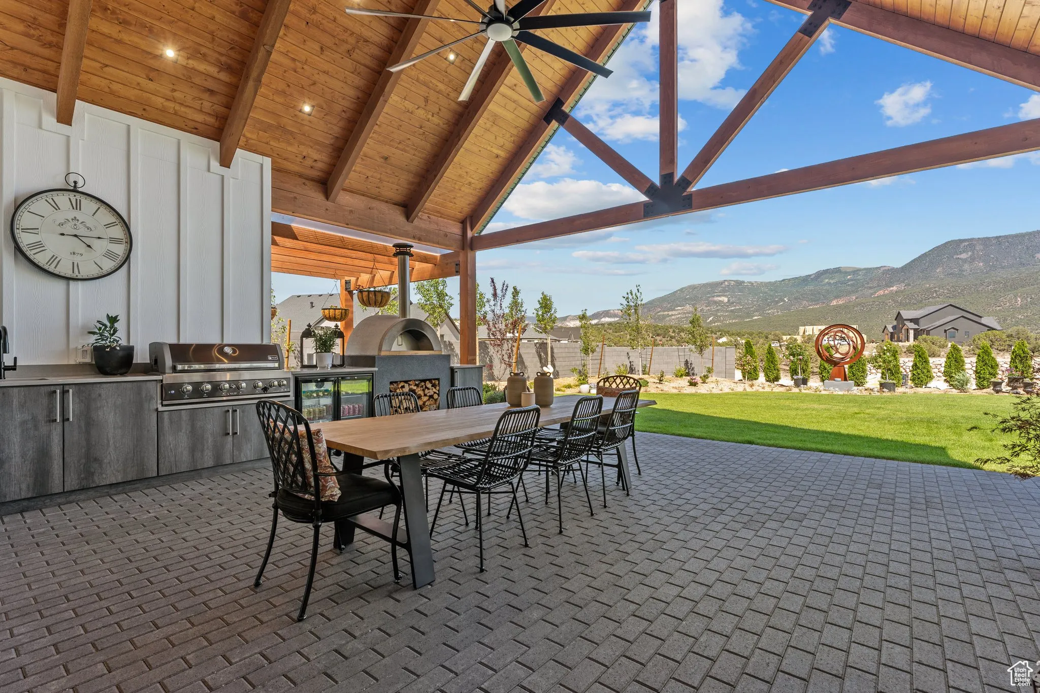 View of patio / terrace featuring area for grilling, outdoor dining space, a mountain view, and ceiling fan