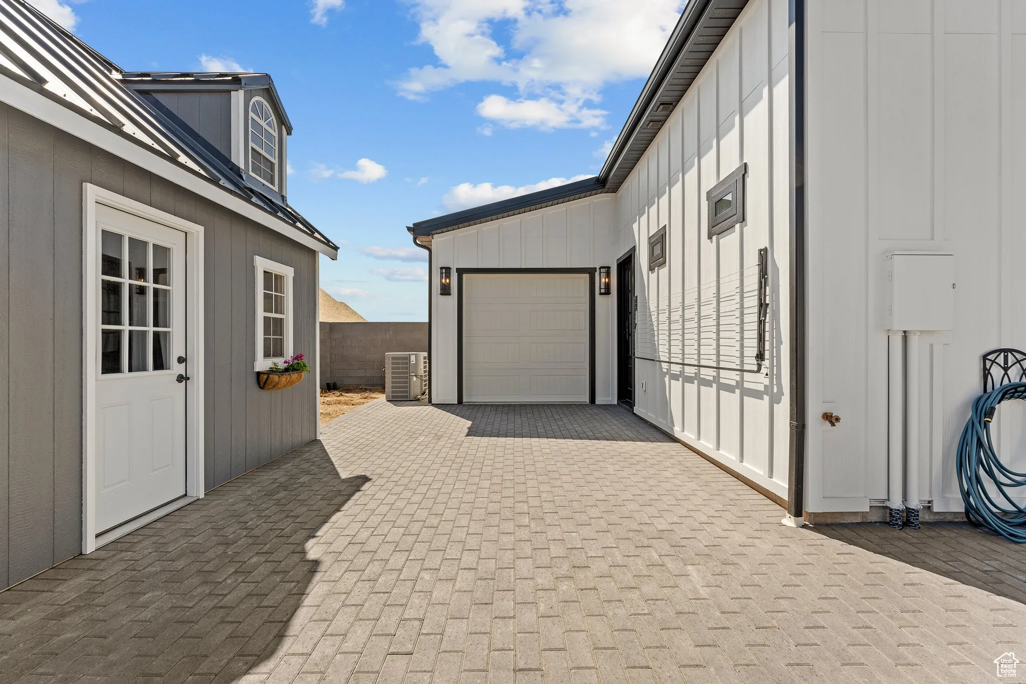 Garage featuring decorative driveway